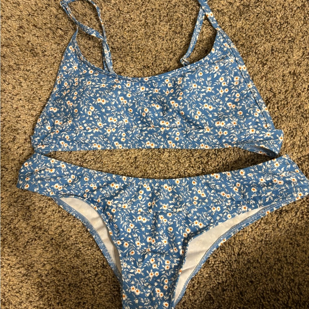 Women’s bikini, blue with yellow and white flowers. Straps are adjustable